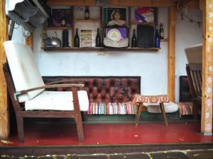 a living room with a couch and a chair at Hikers Hostel in Plovdiv