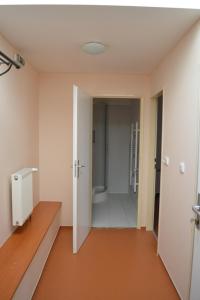 an empty room with a bathroom with a walk in shower at Stará Fara in Chržín