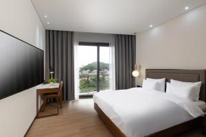Voodi või voodid majutusasutuse N Bridge Hotel JEON JU toas