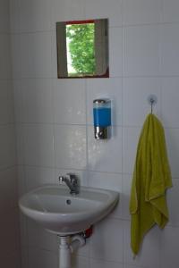a bathroom with a sink and a green towel at Stará Fara in Chržín