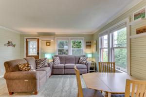 a living room with a couch and a table at Bay View Bungalow in Poulsbo