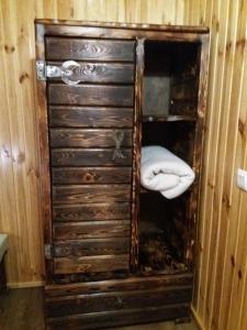 a wooden cabinet with a bed inside of it at Hotel Dudarik in Kosiv