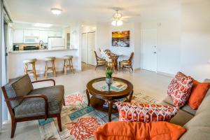 a living room with a couch and a table at SandPiper #116a in Princeville