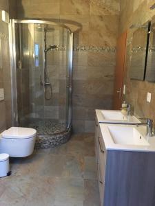 a bathroom with a shower and a toilet and a sink at Queen Guest Room in Mont-sur-Rolle