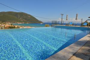 a large swimming pool with a view of the ocean at Katerina Lefkada in Vasiliki