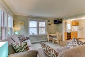a living room with a couch and a table and a kitchen at Bay View Bungalow in Poulsbo