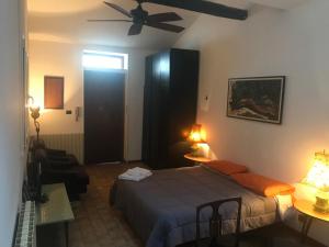 a bedroom with a bed and a ceiling fan at Mood-Cavour in Pavia