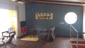 - un salon avec un canapé et un tableau mural dans l'établissement PIPA DÚPLEX & SUÍTE hyper-centro, à Pipa