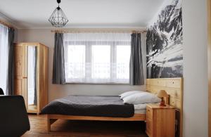 Posteľ alebo postele v izbe v ubytovaní Apartamenty JSZI