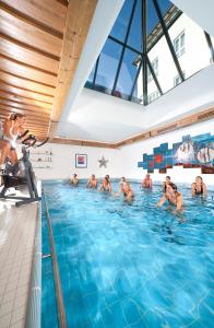 a group of people in a swimming pool at Kneipp- und Wellvitalhotel Edelweiss in Bad Wörishofen