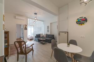 a living room with a table and a couch at Piraeus_Faliro_Cosy apartment in Piraeus