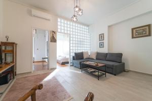 a living room with a couch and a table at Piraeus_Faliro_Cosy apartment in Piraeus