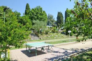 a ping pong table in the middle of a park at Fattoria I Tribbi in Ambra