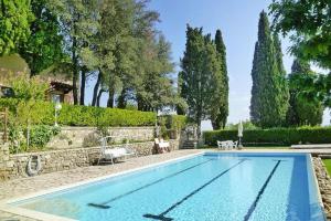 a swimming pool in a yard with trees at Fattoria I Tribbi in Ambra