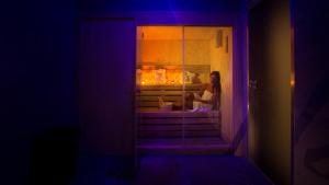 a woman sitting in a window in a room at Hotel Crawford in Sant'Agnello