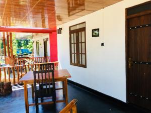 a room with a table and chairs and a door at La Casa Safari Resort in Udawalawe +58 photos