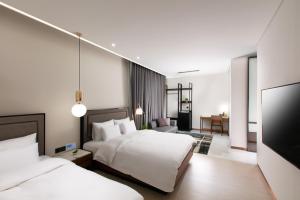 Voodi või voodid majutusasutuse N Bridge Hotel JEON JU toas