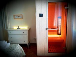 a bedroom with an orange door and a dresser at La Fattoria di Tirrenia in Tirrenia +37 photos