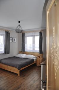 Posteľ alebo postele v izbe v ubytovaní Apartamenty JSZI