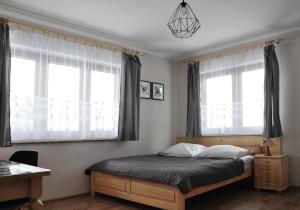 Posteľ alebo postele v izbe v ubytovaní Apartamenty JSZI