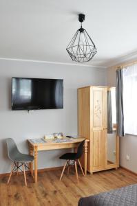 Televízia a/alebo spoločenská miestnosť v ubytovaní Apartamenty JSZI