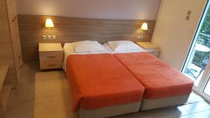 A bed or beds in a room at Alexandros