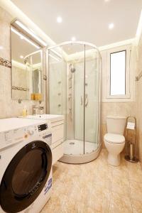 a bathroom with a shower and a washing machine at Chloe Boutique Apartments Metropolis in Athens +21 photos