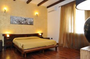 a bedroom with a bed and a large window at Rooms and Breakfast Zefiro in San Vito lo Capo