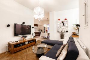 a living room with a couch and a flat screen tv at LUXURY Apartment Dlouha in Prague