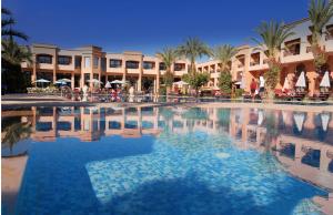 a large swimming pool in front of a resort at Zalagh Kasbah Hotel & Spa in Marrakesh