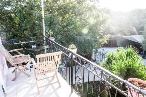 a balcony with a chair and a table at La Casa di Caterina in Lefkada +10 photos