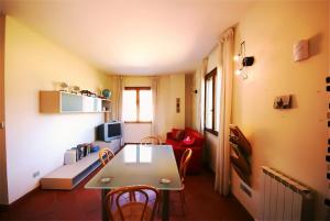 a living room with a table and a couch at La Fattoria di Tirrenia in Tirrenia