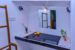 a bathroom with a sink and a mirror at Dimuthu Home Stay in Ella