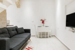 a living room with a couch and a table at 88, Valletta Boutique Escape in Valletta