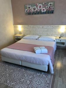 a hotel room with a bed and a desk at Fiumicino Airport B&B Deluxe in Fiumicino