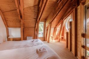a bedroom in a log cabin with two beds at Chalet de Prestige l'Arketa - maeva Home - maeva Home in Avoriaz