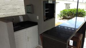 a kitchen with a sink and a counter top at Easy Club 308 in Piçarras