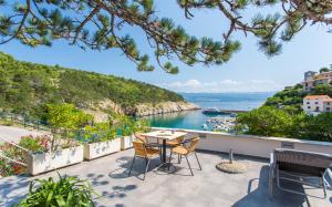 a patio with a table and chairs overlooking the water at Seafront Apartment With Amazing Seaview in Vrbnik