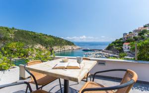 a table on a balcony with a view of the water at Seafront Apartment With Amazing Seaview in Vrbnik