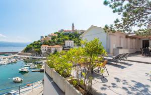 a view of a harbor with boats in the water at Seafront Apartment With Amazing Seaview in Vrbnik +22 photos
