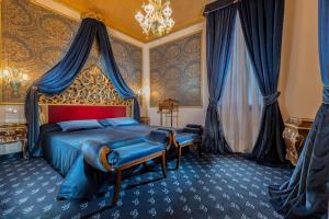 a bedroom with a bed with a red headboard at Hotel Giorgione in Venice