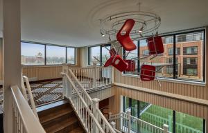 a room with stairs and red shoes hanging from the ceiling at Graduate Bloomington in Bloomington