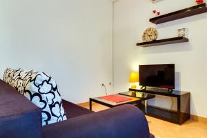 a living room with a couch and a tv at Guesthouse Katica in Barban