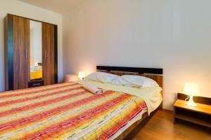 a bedroom with a large bed with a colorful blanket at Guesthouse Katica in Barban