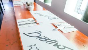 a table with a sign on it and a sign on the wall at Blanc Kara- Adults Only in Miami Beach