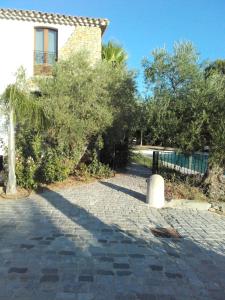 a house with trees and a brick walk way at Studios Domaine l'Oliveraie in Le Castellet