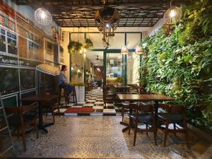 a woman sitting at a table in a restaurant at Beauty House in Ho Chi Minh City