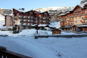 a hotel in the snow with snow covered buildings at Neves in Val Thorens