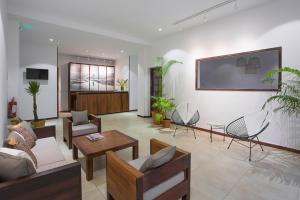 a living room with a couch and a table and chairs at Tsanga Tsanga Hotel in Antananarivo