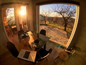 a dining room with a table and a large window at Apartma Vita in Dobrovo